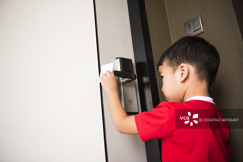 小男孩手持门卡侧视图图片素材