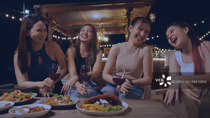 与好友在豪华酒吧享用小吃和饮品的欢乐聚会图片素材