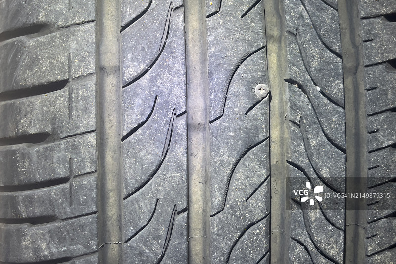 轮胎上扎着钉子，轮胎已磨损并有孔洞图片素材