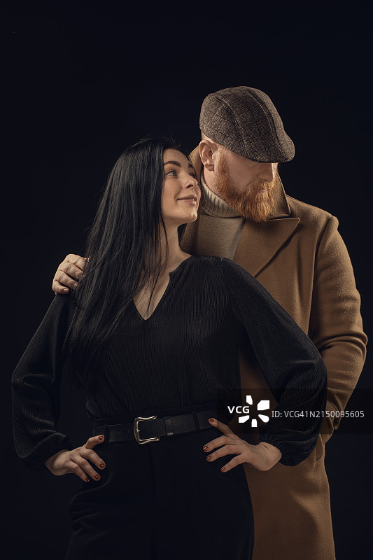 英俊的红发绅士男性黑帮与美丽的黑发女子合影图片素材