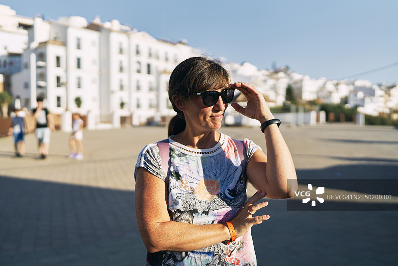 戴着太阳镜在街上的女游客肖像图片素材