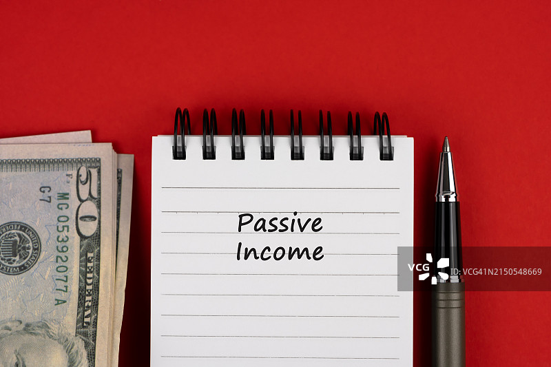 带有被动收入字样的美元和笔记本图片素材