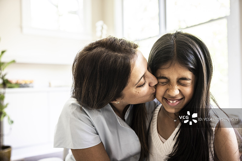 母亲在家亲吻小女儿图片素材