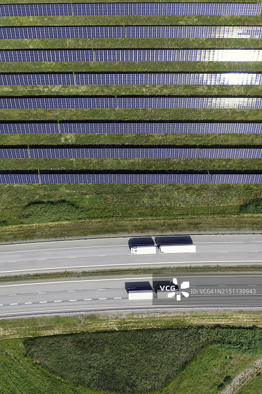 高速公路旁太阳能发电场边的卡车图片素材