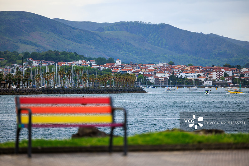 从洪达里比亚到昂代，俯瞰比达索阿河的彩色长椅图片素材