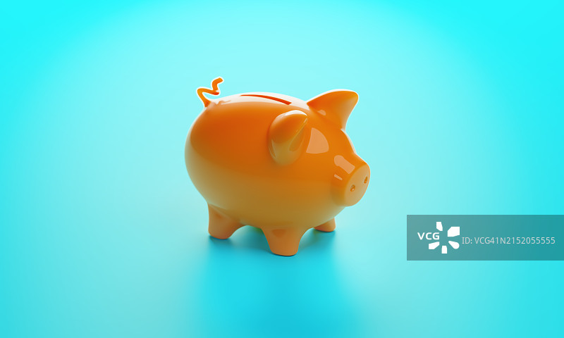 蓝色背景上的橙色小猪储蓄罐图片素材