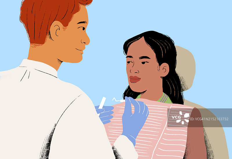 牙医在蓝色背景下检查病人图片素材