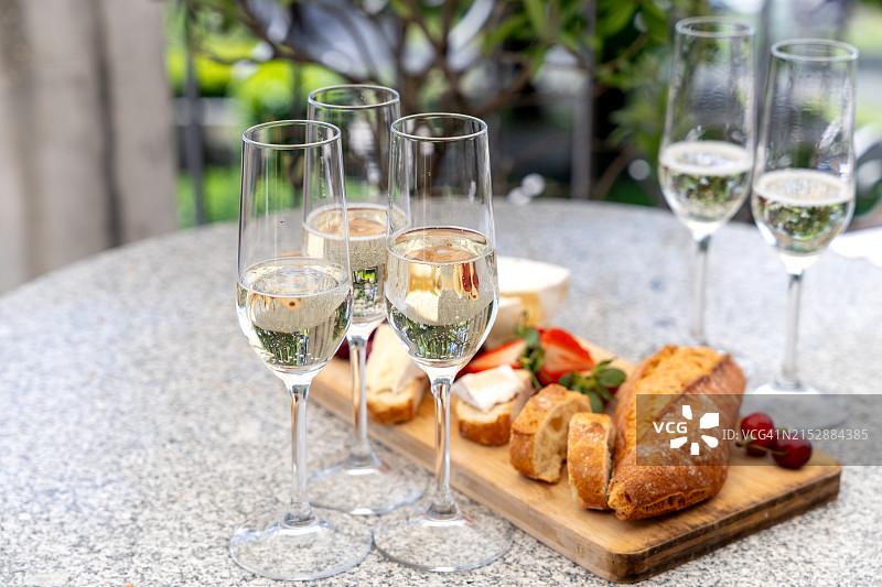 香槟酒杯、法棍、布里奶酪、樱桃和草莓法式开胃小点心图片素材