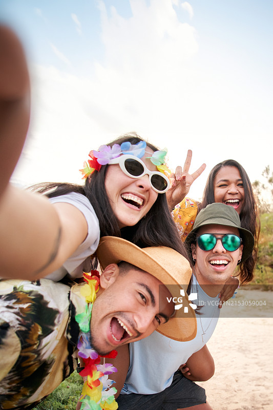 两对情侣在海滩派对上自拍图片素材