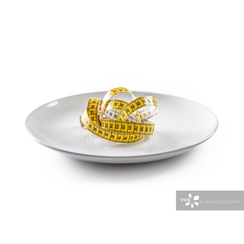 节食：空盘中的黄色卷尺图片素材