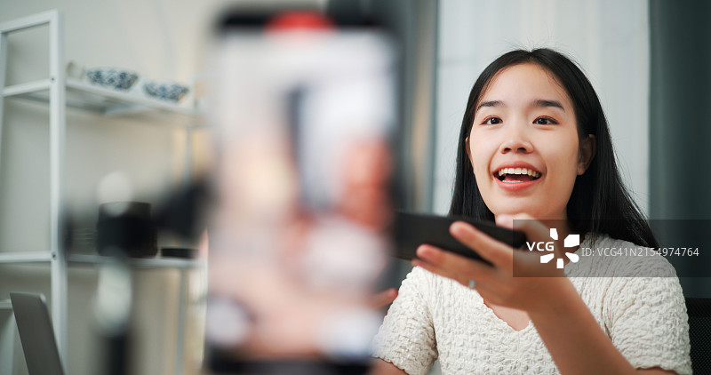 年轻女商人正在家中直播向顾客售卖陶瓷碗图片素材