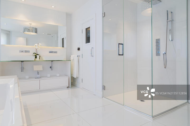 豪华住宅内带瓷砖地板的白色浴缸和浴室图片素材