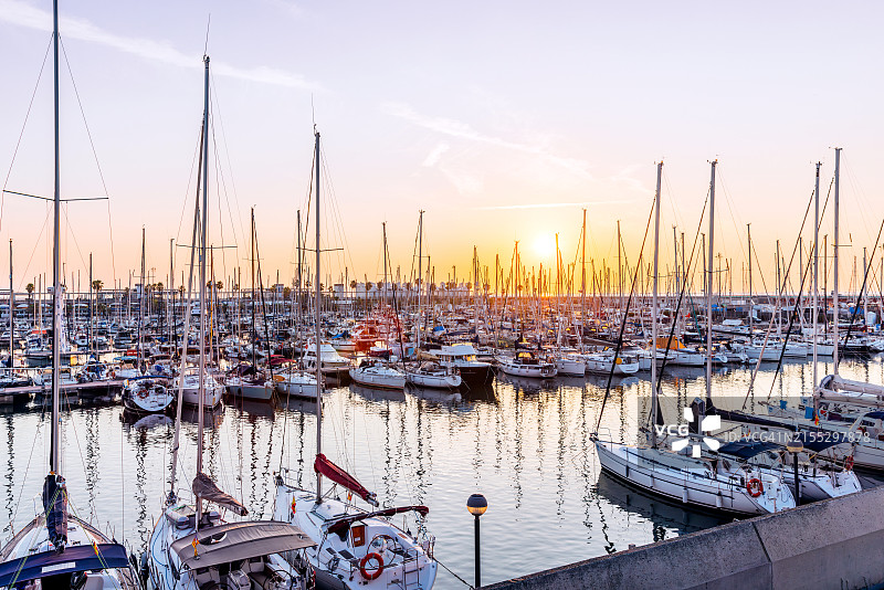 西班牙加泰罗尼亚巴塞罗那奥林匹克港日出时的游艇图片素材