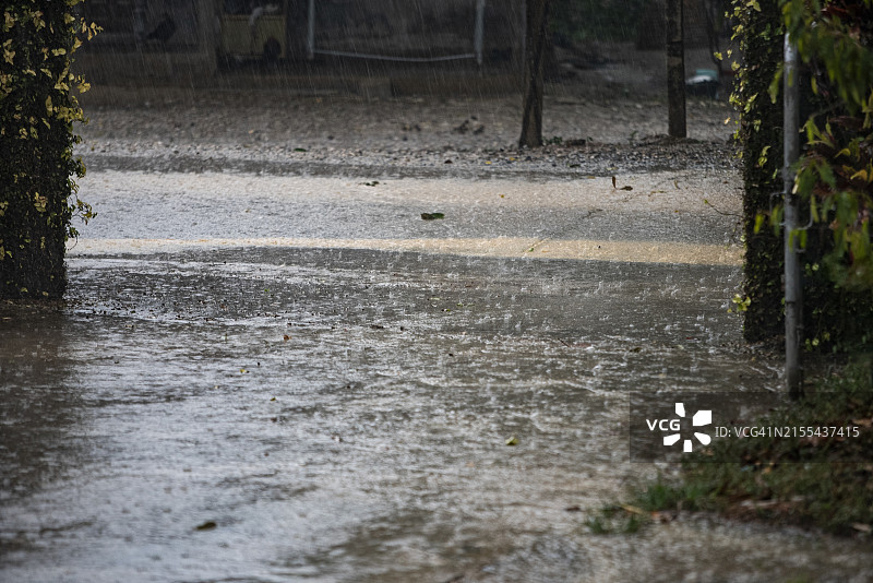 暴雨和大风吹袭屋顶，倾盆大雨的特写，极端气候概念图片素材