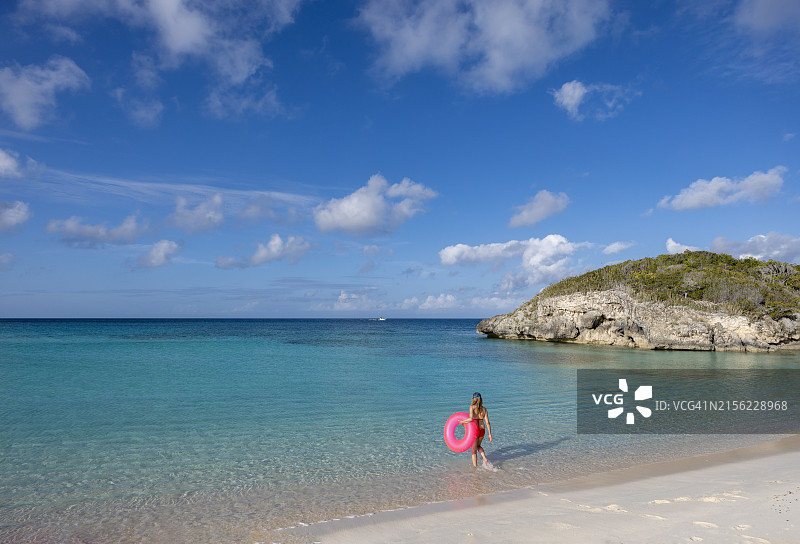 漂浮在翡翠色水面上的女人，斯托金岛，埃克苏马，巴哈马图片素材