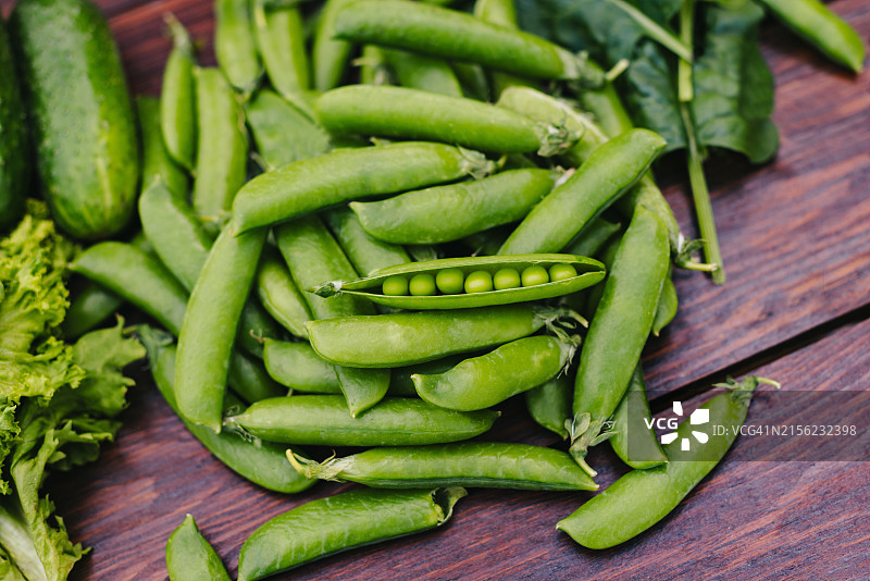 打开的年轻绿豌豆豆荚特写，绿色蔬菜图片素材