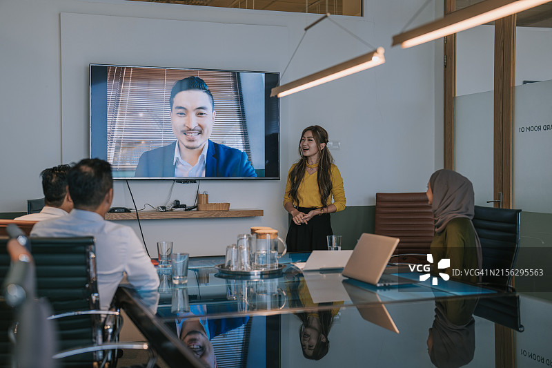 亚洲商务人士在办公室会议室通过电视进行视频会议图片素材