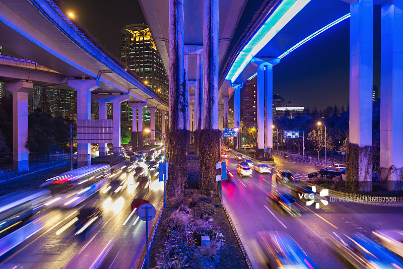 上海市中心夜晚的道路交叉口与霓虹灯光，交通繁忙图片素材