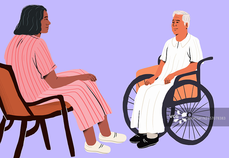 护理人员与坐在轮椅上的老年男人交谈图片素材