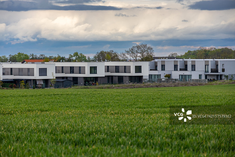 绿色田野中的现代住宅楼群图片素材