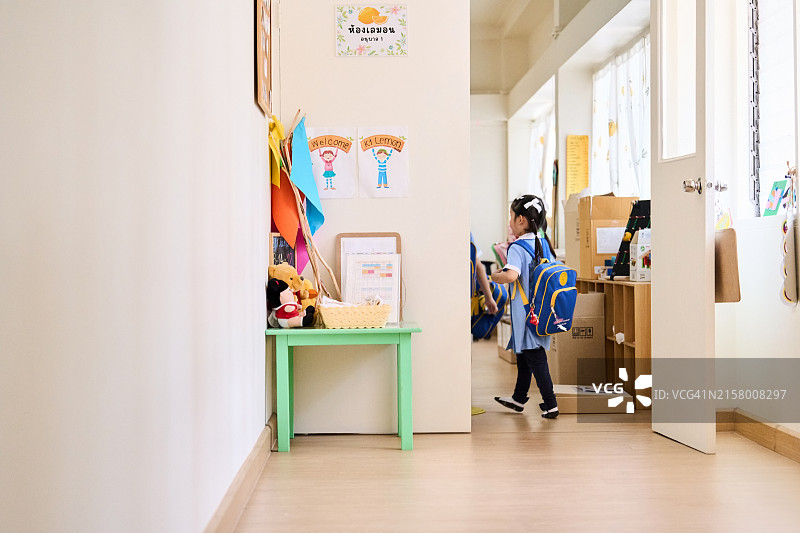 女学生进入幼儿园教室图片素材
