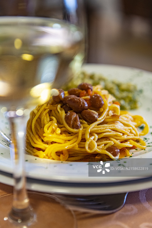 意大利面和一杯白葡萄酒图片素材