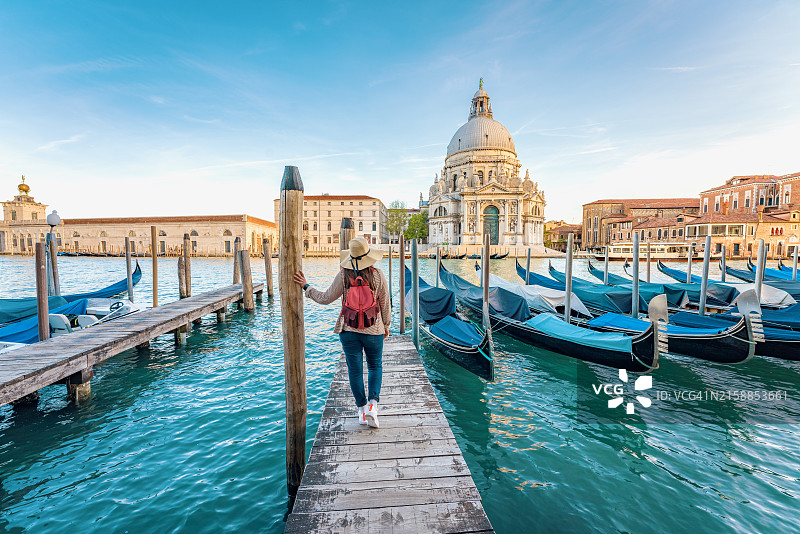 意大利威尼托威尼斯大运河上的贡多拉和游客，俯瞰着圣玛丽亚德拉萨卢特教堂图片素材
