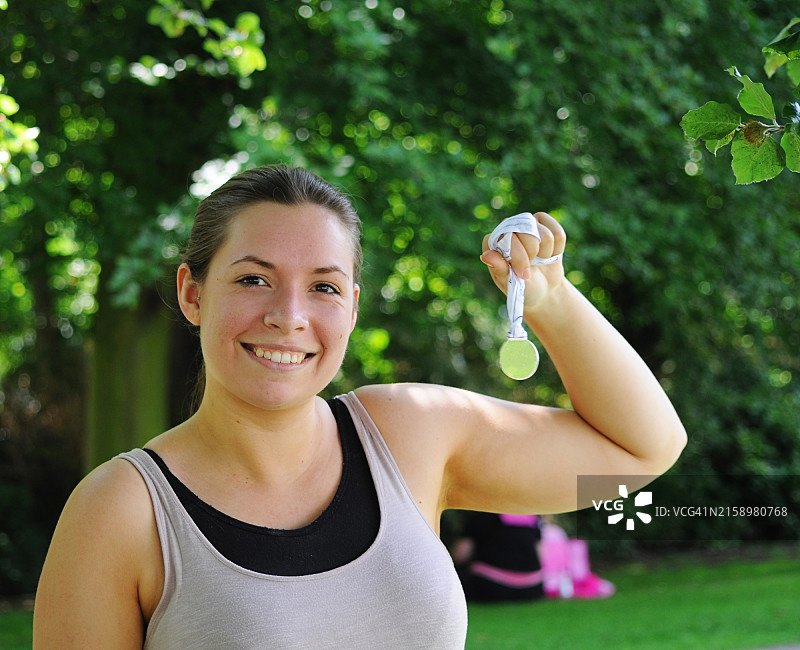 佩戴比赛奖牌的年轻女子图片素材