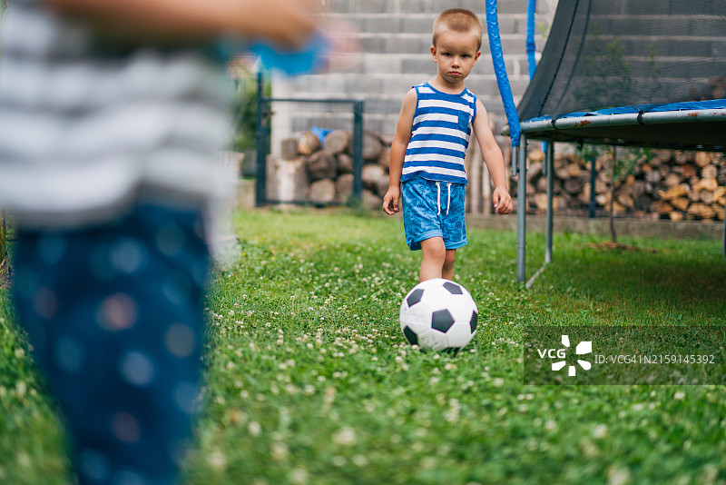 男孩们在后院踢足球图片素材