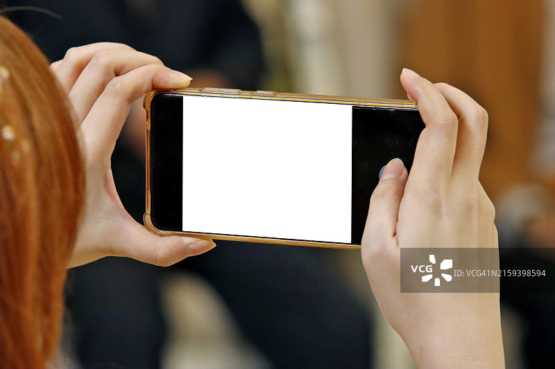 手持智能手机进行录制或拍照图片素材