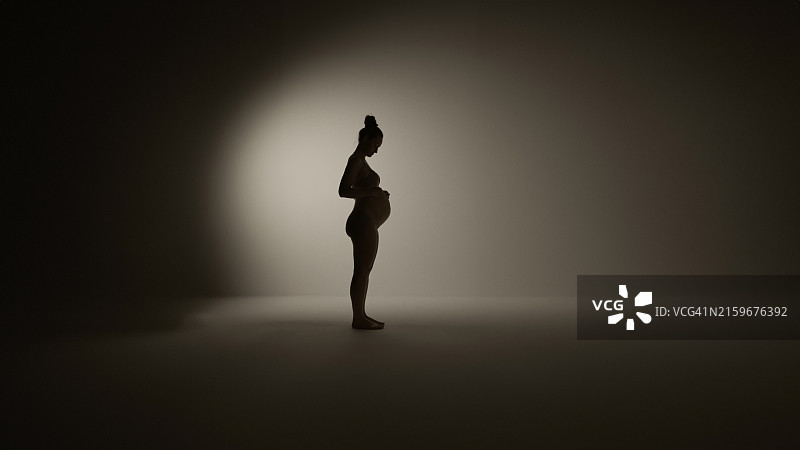 孕妇轻抚腹部的剪影图片素材