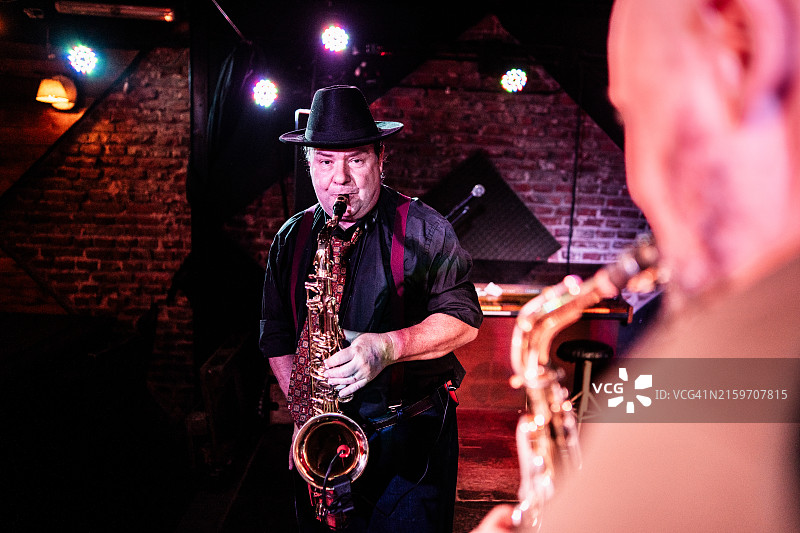 在夜总会演奏萨克斯管的音乐家图片素材