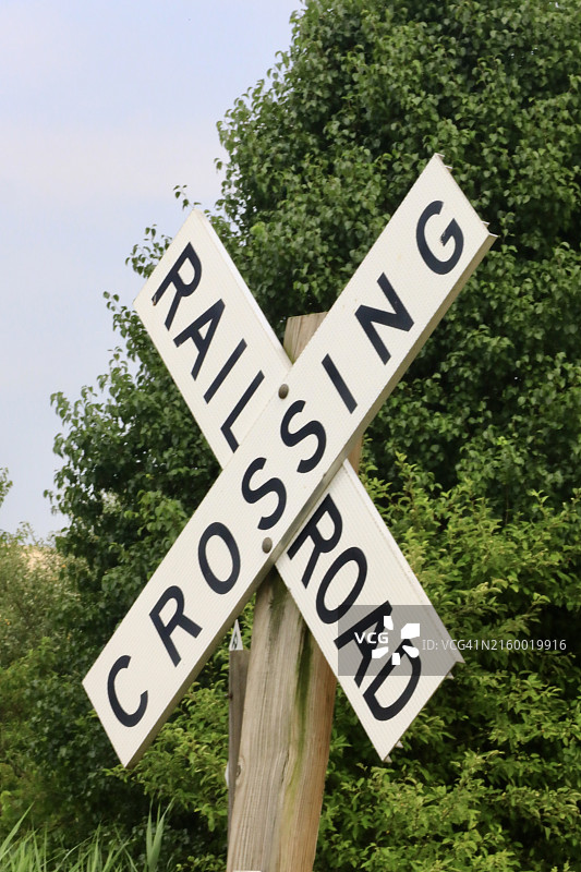 铁路轨道和火车穿过道路的警告标志图片素材
