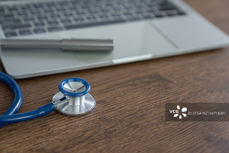 医生桌上的听诊器与笔记本电脑图片素材