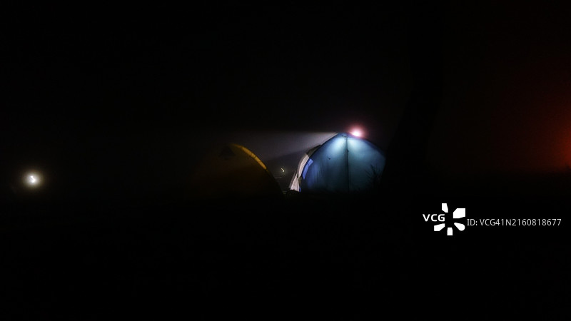 黑暗夜晚中闪耀的露营帐篷图片素材