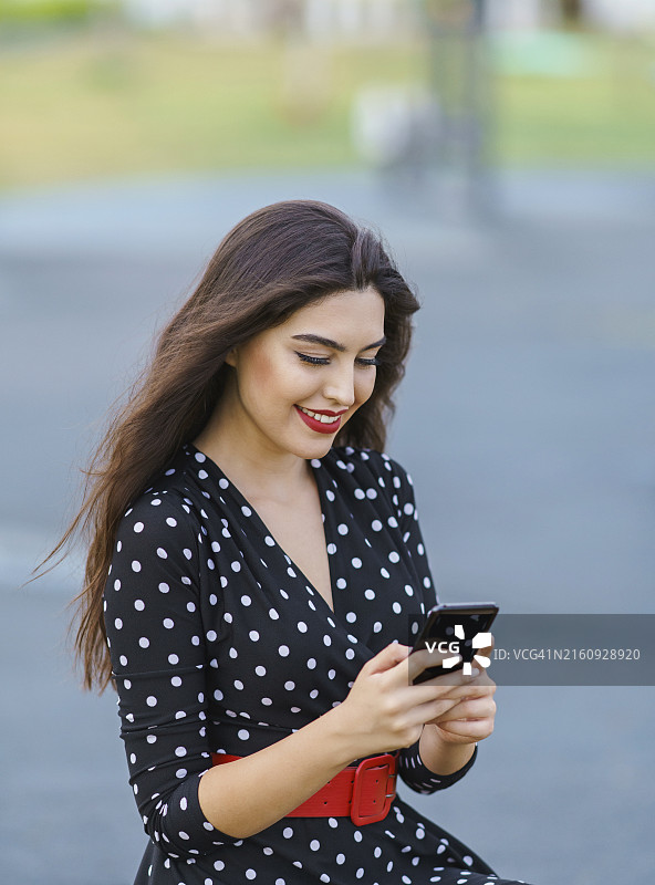 使用智能手机的年轻漂亮女人图片素材