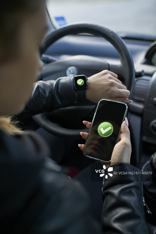 年轻女人在车内连接便携设备图片素材