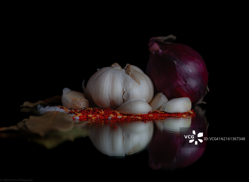 黑色背景上的大蒜、洋葱和香草图片素材