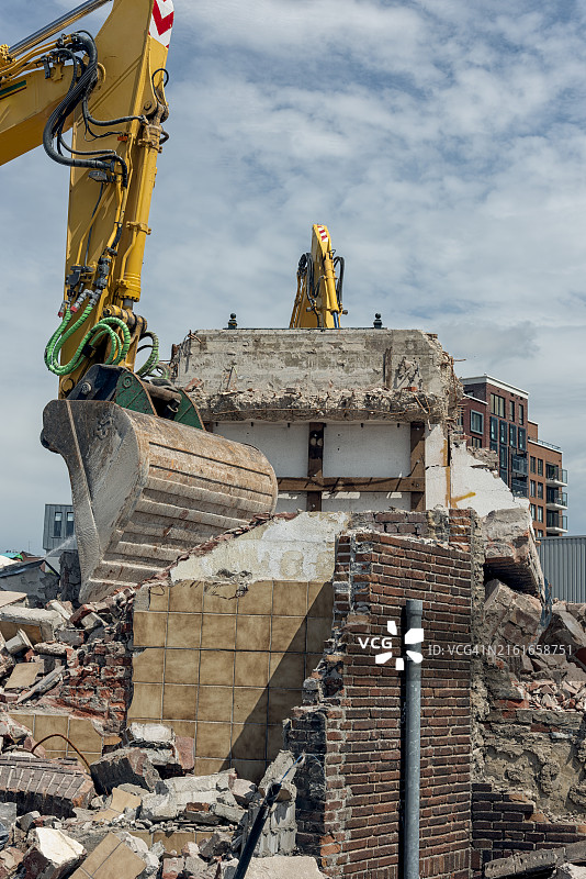正在拆除剩余建筑物的钢制铲斗图片素材