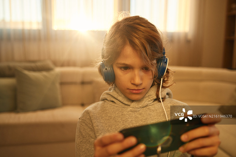 男孩在家玩电子游戏图片素材