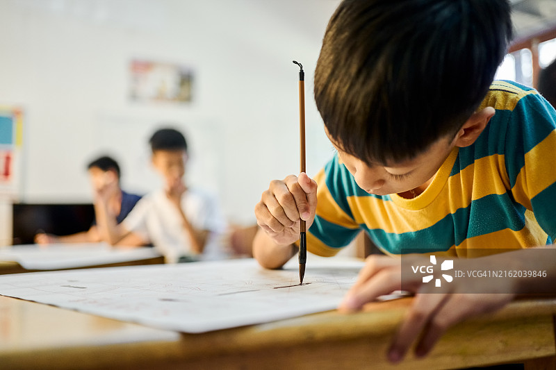 男孩在学校教室学习中国书法图片素材