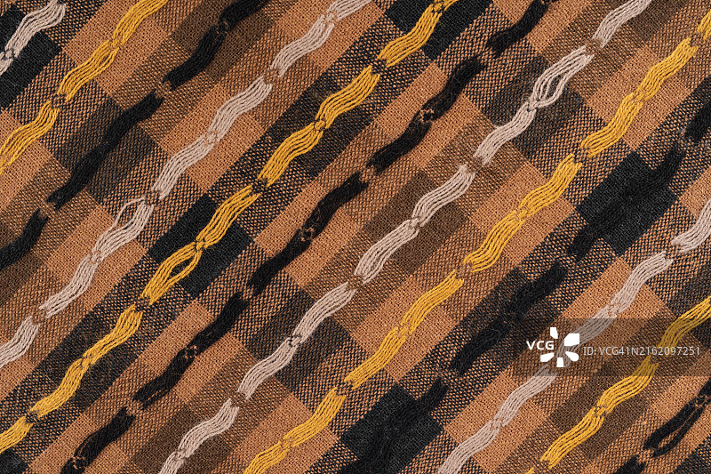 带有黄色条纹图案的棕色布背景，纺织背景，俯视图片素材