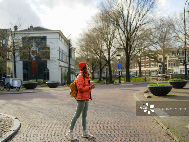 在荷兰乌得勒支使用智能手机行走的女人图片素材