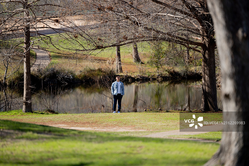 站在美国德克萨斯州奥斯汀湖岸边的男子全身像图片素材