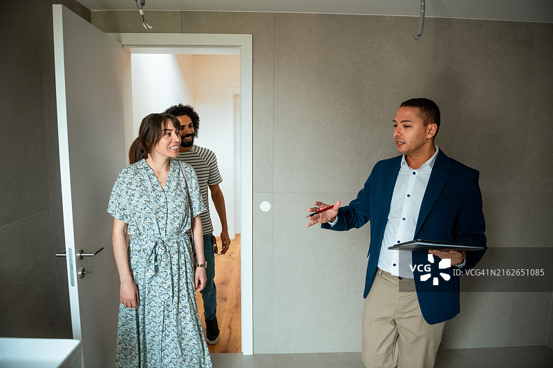 情侣与房产经纪人参观新房图片素材