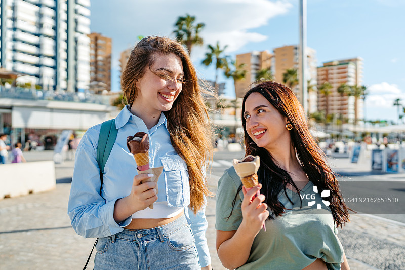 两位女性朋友在西班牙马拉加码头吃冰淇淋图片素材