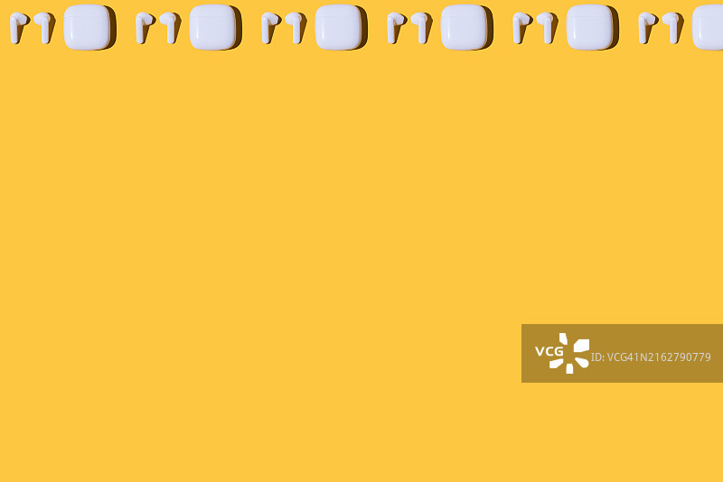 黄色背景上现代无线白色耳机图案图片素材