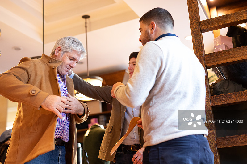 服装店员帮助男顾客图片素材