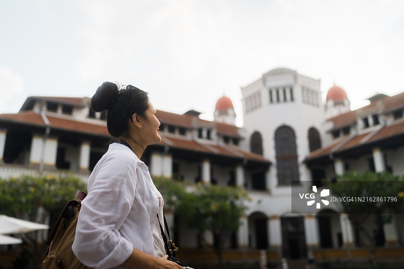 在三宝垄用相机拍摄Lawang Sewu荷兰车站的成年游客图片素材