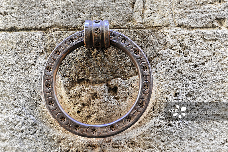 意大利托斯卡纳沃尔泰拉：石墙上的古董金属门环特写图片素材